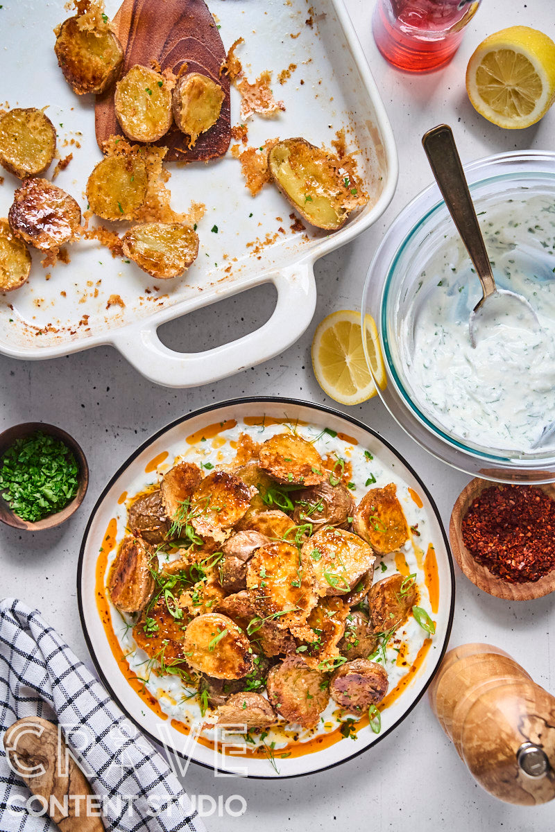 Crispy Parmesan Potatoes with Herby Yogurt and Chili Oil