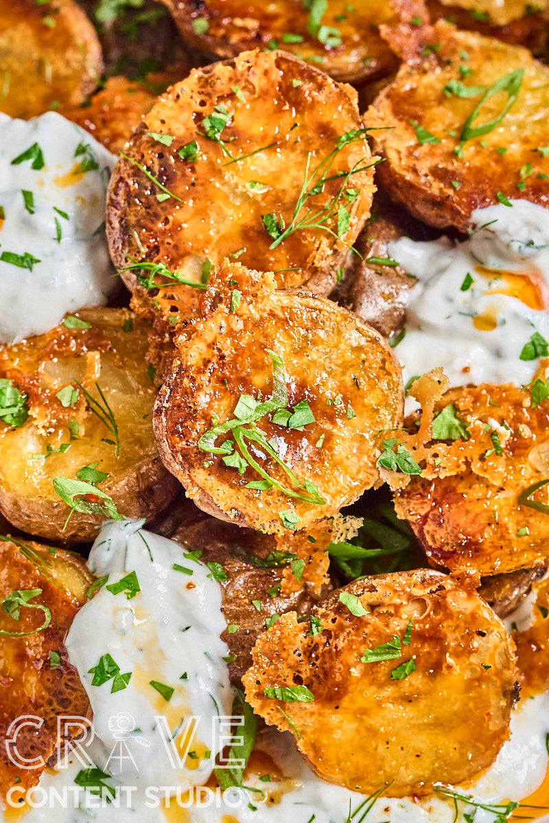 Crispy Parmesan Potatoes with Herby Yogurt and Chili Oil