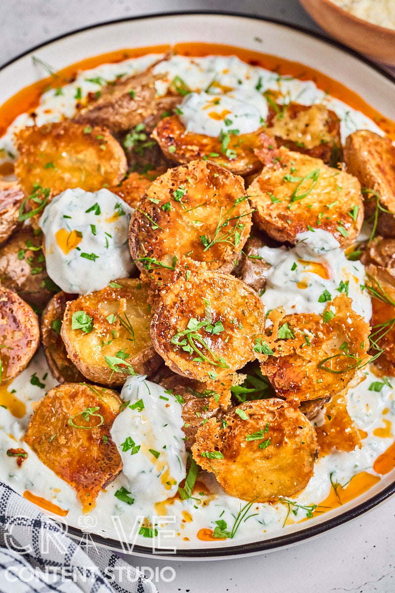 Crispy Parmesan Potatoes with Herby Yogurt and Chili Oil