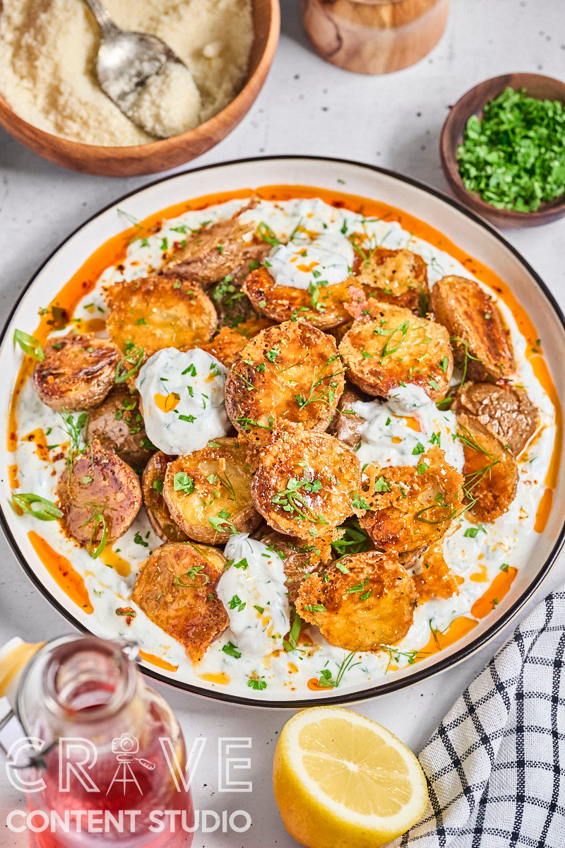 Crispy Parmesan Potatoes with Herby Yogurt and Chili Oil