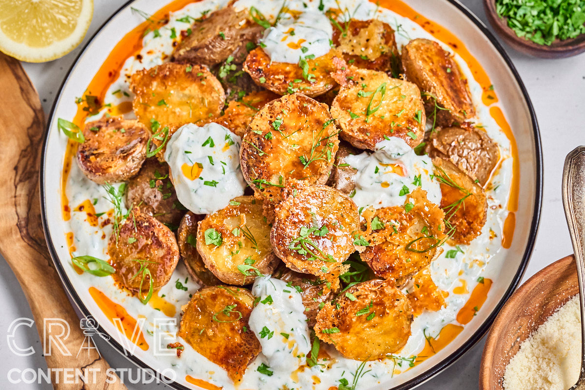 Crispy Parmesan Potatoes with Herby Yogurt and Chili Oil