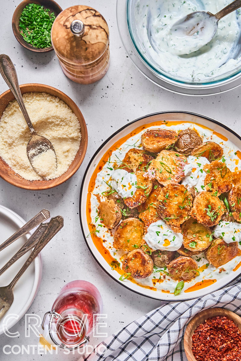 Crispy Parmesan Potatoes with Herby Yogurt and Chili Oil