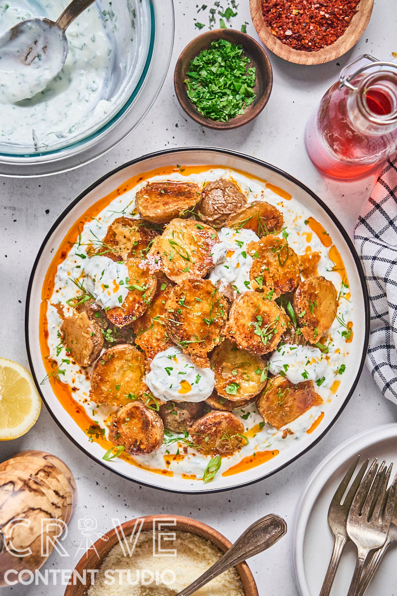 Crispy Parmesan Potatoes with Herby Yogurt and Chili Oil