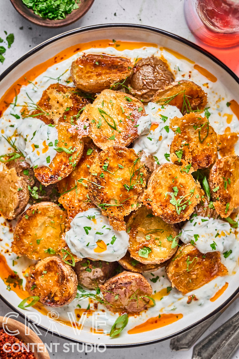 Crispy Parmesan Potatoes with Herby Yogurt and Chili Oil